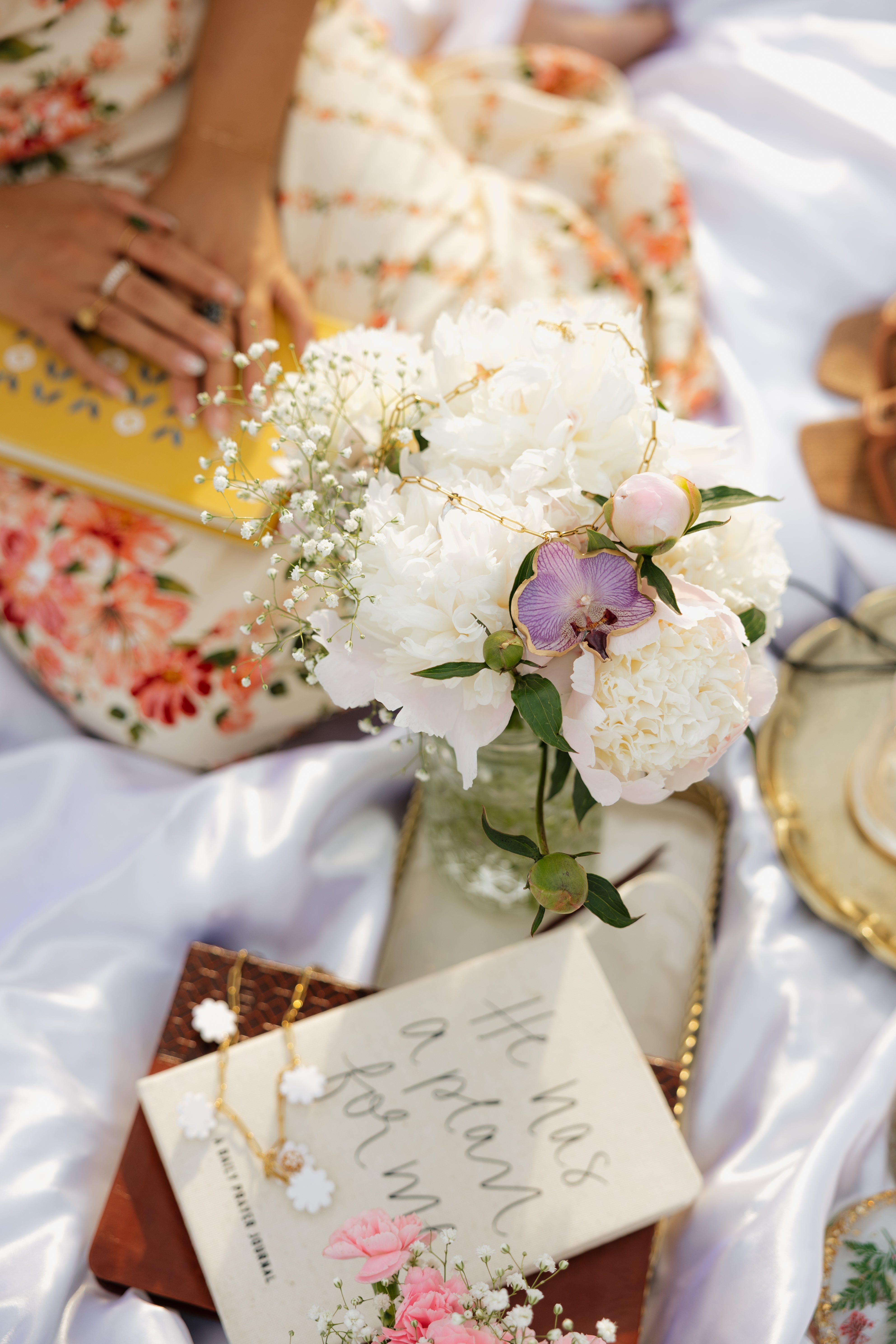 Bouquet of white flowers with a card on a white surface